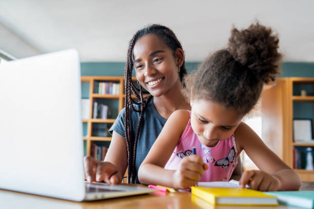 istock A mother helping her daughter with homeschool. 1298646722