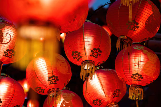 Rows of colorful glowing red Chinese lanterns Rows of colorful glowing red Chinese lanterns hanging high across the street during Chinese New Year Celebrations. lunar new year stock pictures, royalty-free photos & images