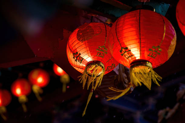 istock Rows of colorful glowing red Chinese lanterns 1298648246