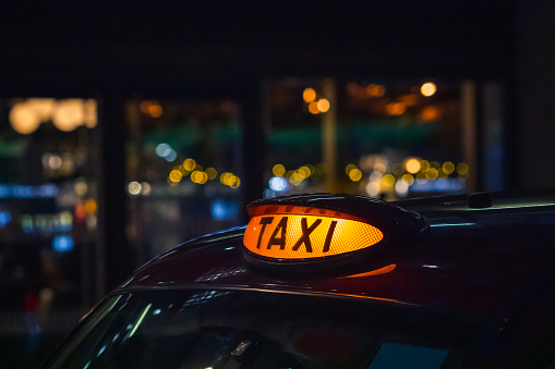 London black cab taxi sign at night