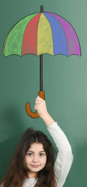 istock Pre-adolescent child holding painted colored umbrella 1298650403