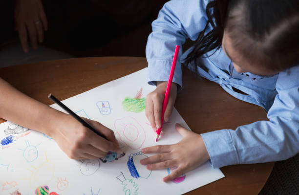 istock Asian parent teaching child how to draw at home 1298653832