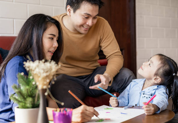 istock Asian parents teaching child how to draw at home 1298653863