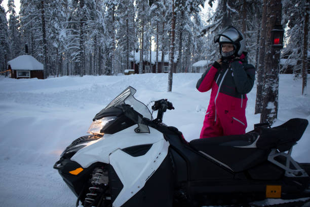 istock Woman wearing crash helmet for snowmobile 1298655701