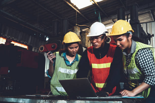 istock Factory job workers working and discussing manufacturing plan in the factory 1298659094