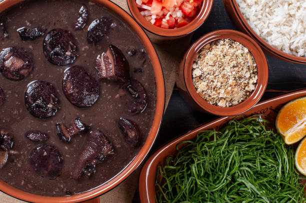 istock Typical Brazilian dish called Feijoada. Made with black beans, pork and sausage. Top view 1298659283