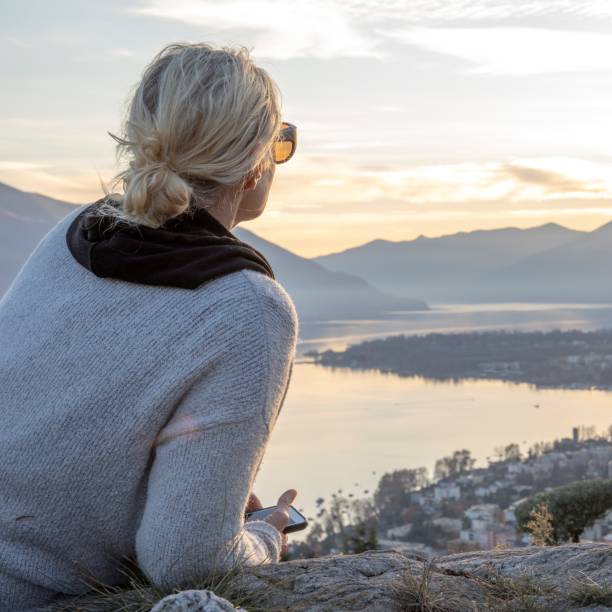 istock Female hiker relaxes on mountain ridge at sunrise 1298659568