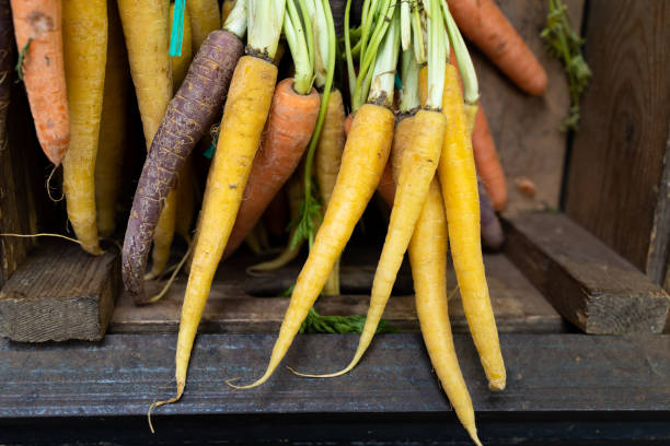 istock Beautiful fresh carrots in a wooden box 1298664103