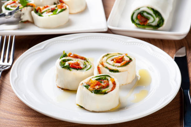 istock Buffalo mozzarella roll stuffed with dried tomatoes and arugula. 1298664468