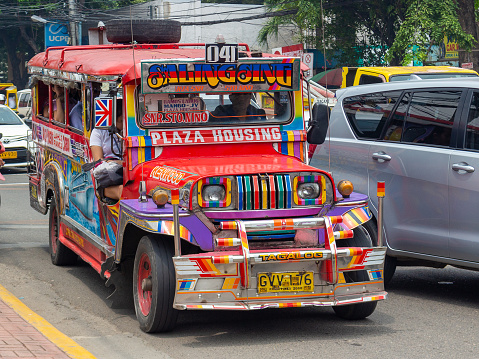 Cebu, Philippines - October 3, 2018: colorful passenger jeepney with bright designs on city street. Popular public transport at Philippines