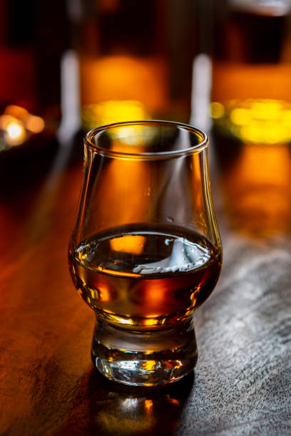 istock Dram of single malt scotch whisky and bottles on background 1298667397
