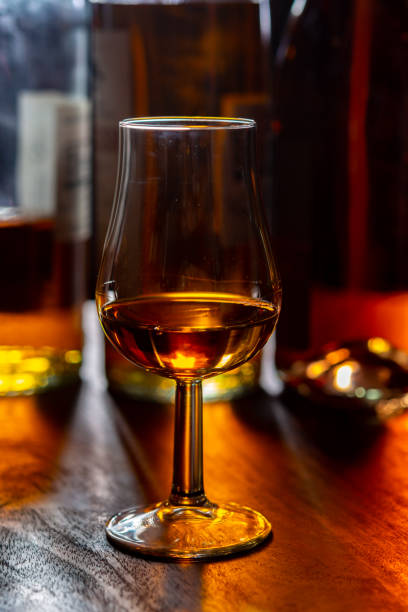 istock Dram of single malt scotch whisky and bottles on background 1298667406