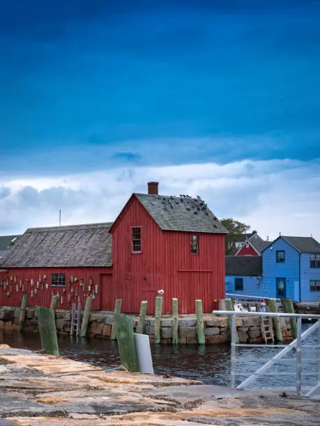 Photo of Red Rustic Boat House at the Stone Dock Commercial Marina with Buoys Hanging on the Wall