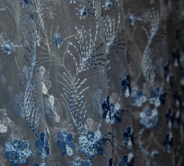 istock Beautiful tulle fabric with embroidered flowers and patterns. 1298671204