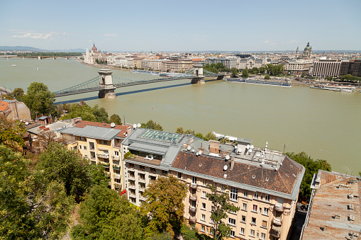 Budapest, Hungary - July 19, 2012: Panoramic view of the Danube river, at noon, with the famous Chain Bridge in the background, from the viewpoints of the Buda Castle, photography without filters.
