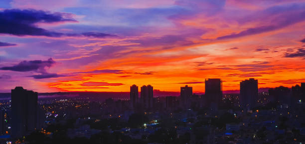istock Sunset colorful sky with clouds skyline city background 1298674430