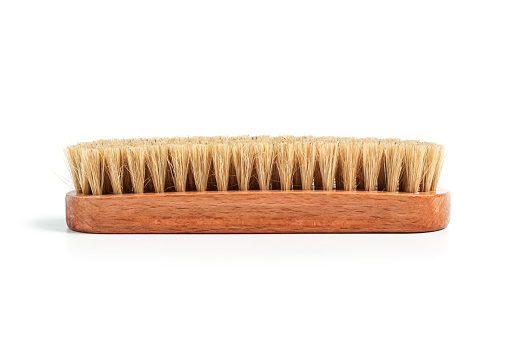 Clothing brush with wooden handle isolated on white background