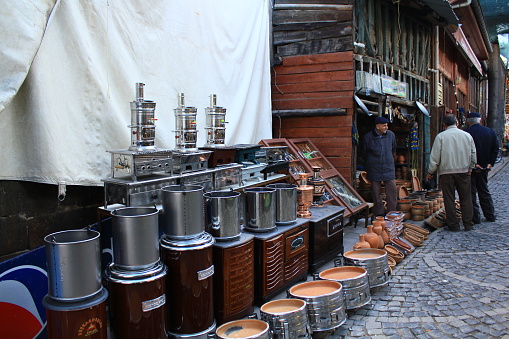 Ankara, Turkey-October 15, 2011: Old-style Iron Stoves and Boilers in Beypazari Bazaar, Three Middle-Aged Men Negotiate.