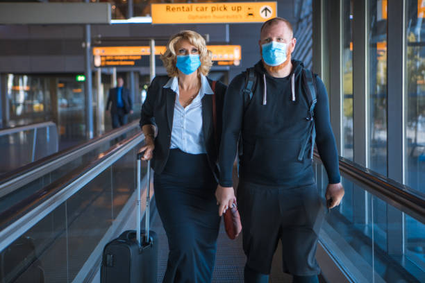 istock Corona practices for an airport traveller couple 1298679184