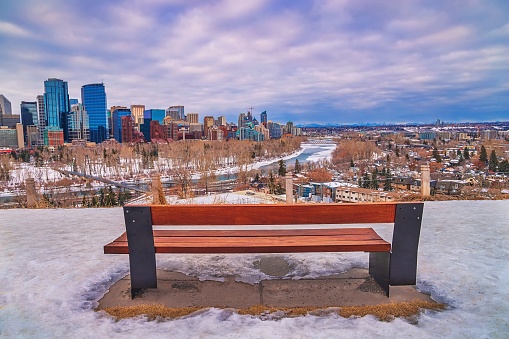 A moody and cloudy sky over the downtown Calgary river valley in the winter.