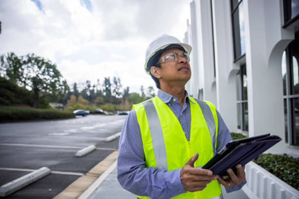 Mature Filipino Man with Tablet Inspecting a Building