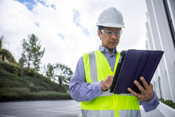 istock Mature Filipino Man with Tablet Inspecting a Building 1298681311