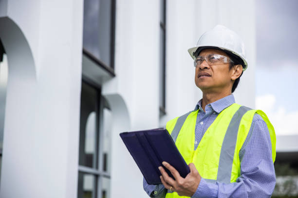 istock Mature Filipino Man with Tablet Inspecting a Building 1298682640