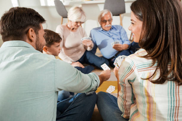 istock Three-generational family playing cards together 1298682665