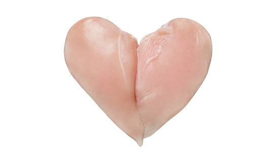 Heart of raw chicken breasts, a symbol of love for Valentine's Day isolated on a white background with clipping path. Full depth of field.