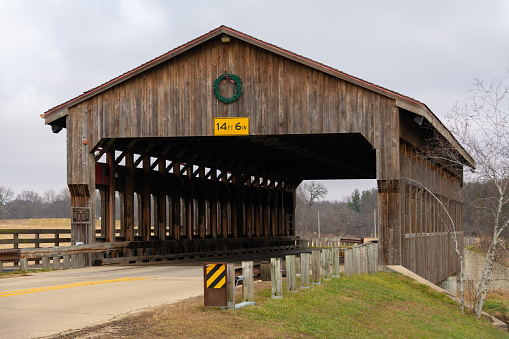 Wooden covered bridge on a cloudy Winter morning.  Morrison, Illinois, USA