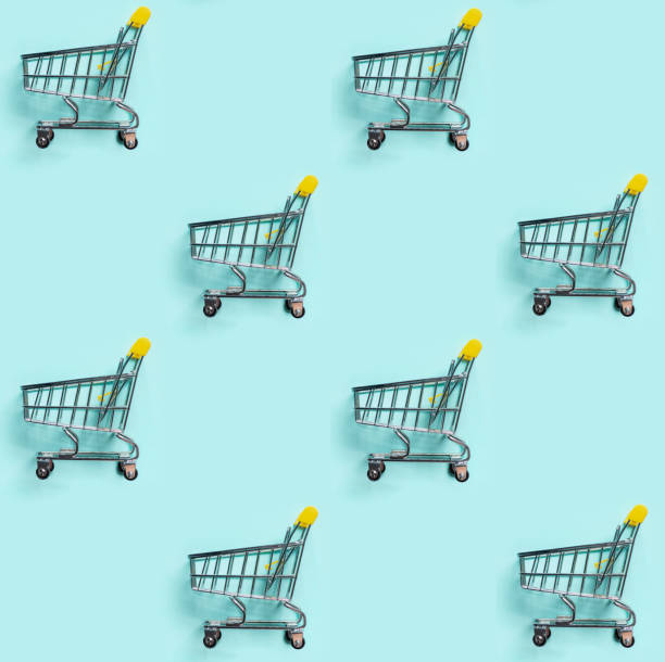 istock Shopping cart staggered on blue. Seamless pattern 1298685230
