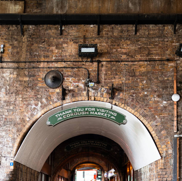 istock Brick wall and pedestrian tunnel with sign 1298688911
