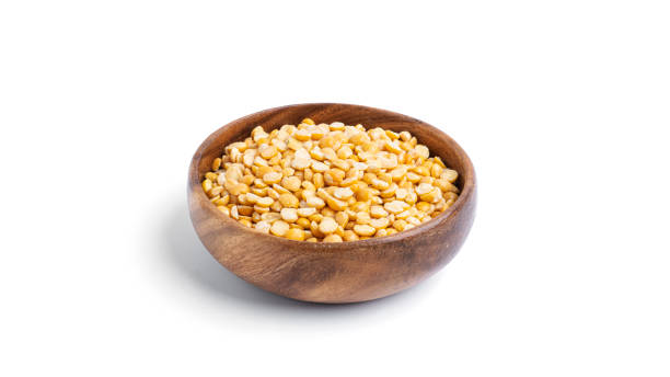 istock Peas in a wooden bowl isolated on a white background 1298690124