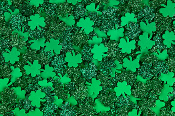 istock Shamrock confetti texture background filled with green lucky clovers 1298690130