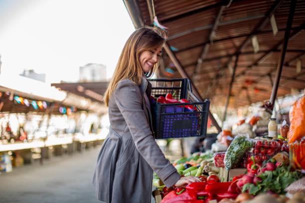 istock Young woman buying vegetables. 1298691339