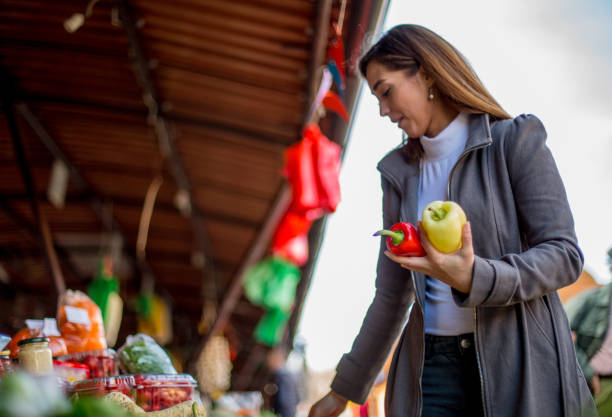 Choosing fresh vegetables on market.