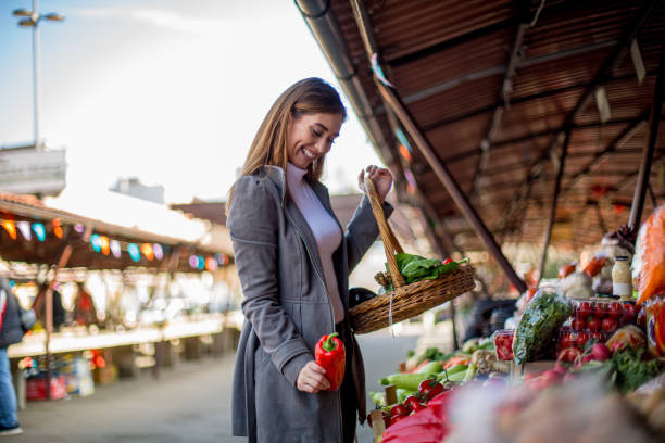 istock Young woman is putting in basket fresh vegetables. 1298691887
