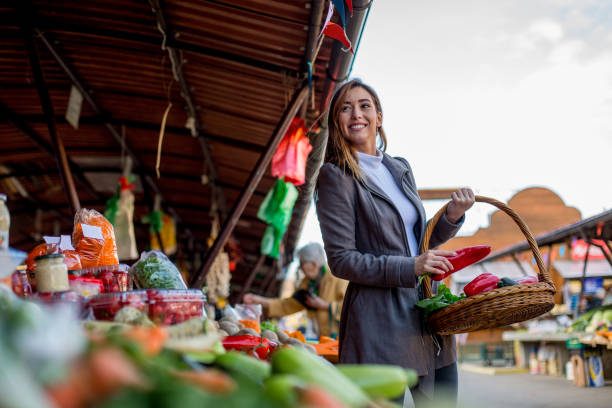 istock Young woman is putting pepper in basket. 1298692268