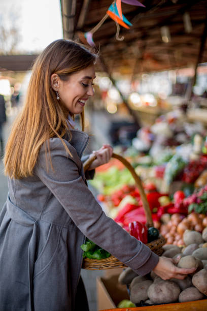 istock Woman is choosing potatoes. 1298692512