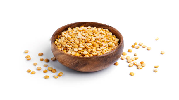 istock Peas in a wooden bowl isolated on a white background 1298692619