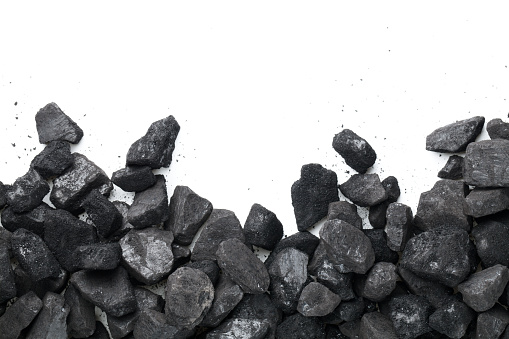 Black coal isolated on white background. Empty room for text. Top view