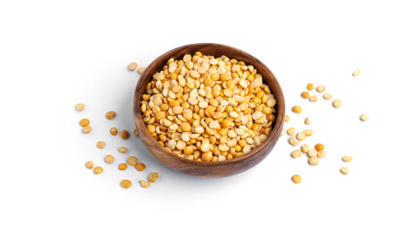 istock Peas in a wooden bowl isolated on a white background 1298693482