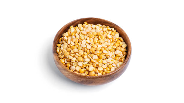 istock Peas in a wooden bowl isolated on a white background 1298693981