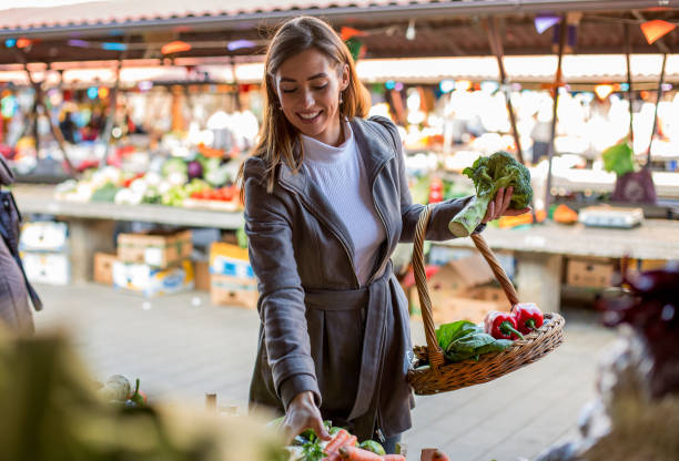 istock Lovely lady is buying fresh vegetables. 1298694384
