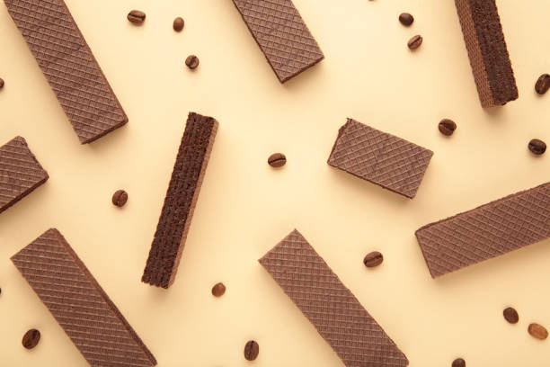 istock Chocolate wafers with coffee on beige background 1298695819