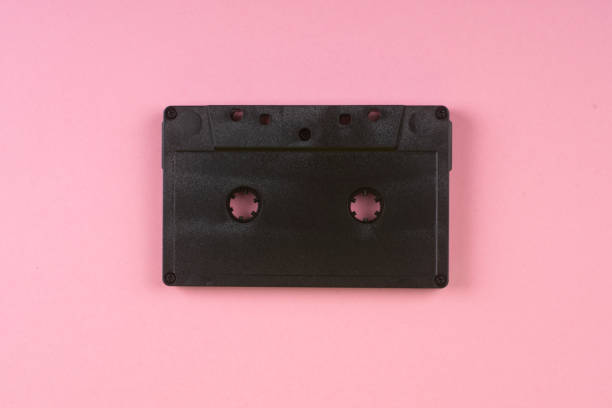 istock Old audio cassette on a pink background. 1298696165