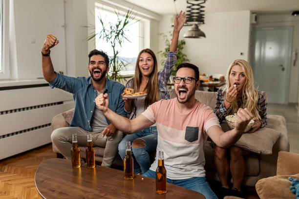 istock Friends watching sport on tv 1298697118
