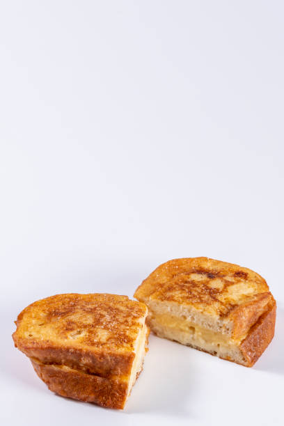 istock Fried bread with milk, egg, sugar, cinnamon and filled with cream (Torrijas). Typical Spanish Easter sweet. Vertical photography and selective focus 1298699042