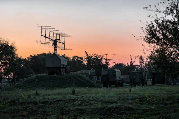silhouettes military mobile radar station at sunset