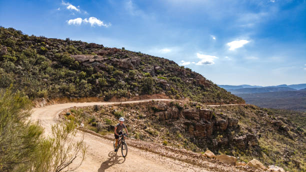istock Boy mountain biking cycling a dirt track mountain pass on a summers day 1298702129
